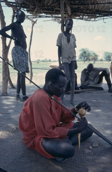 SUDAN, People, "The Acier, a hollow gourd filled with seeds is shaken to summon spirits."