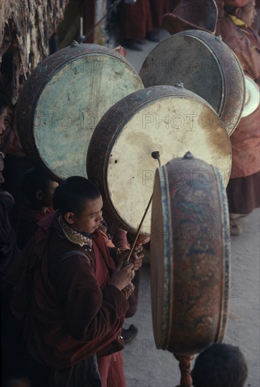 INDIA, Ladakh, "Buddhist musicians playing large, flat monastic drums."