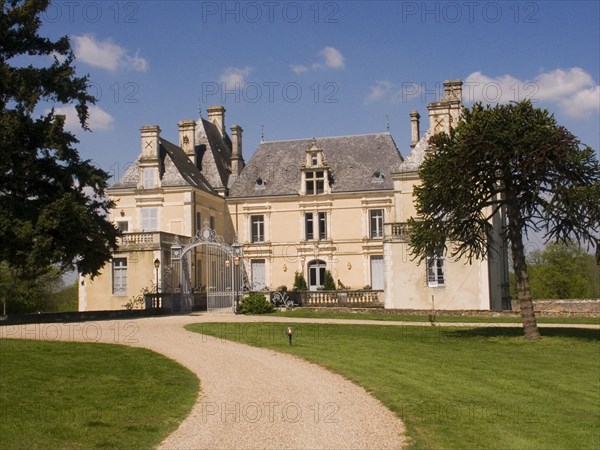 FRANCE, Deux Sevres Region, Poitiers, Gravelled path leading up to the iron entrance gate of the Chateau des Forges.