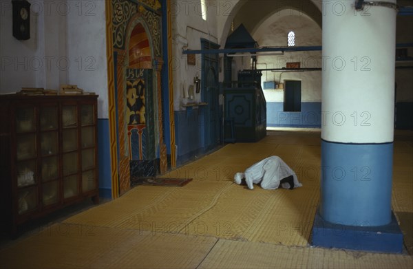 EGYPT, Nile Valley, Man at prayer in village mosque near Aswan.