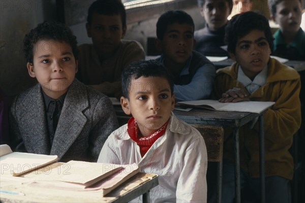 EGYPT, Om Khenan, Primary schoolchildren sitting at desks in classroom of village school.