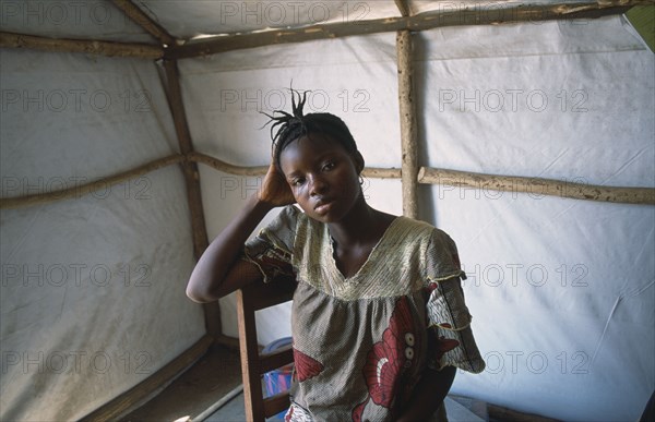 GUINEA, Kissidougou Camp, Portrait of woman in refugee camp for Sierra Leonean  refugees suffering from malaria.