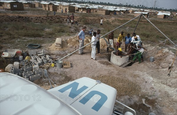 LIBERIA, War, UN peacekeeping team installing water pump and well in refugee camp for people displaced by civil war.