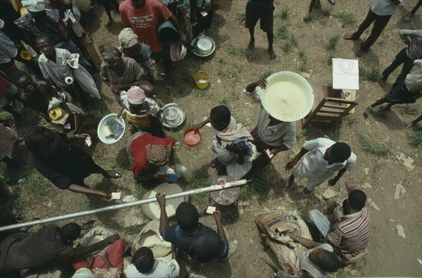 LIBERIA, War, People displaced by civil war queue for UN food aid.