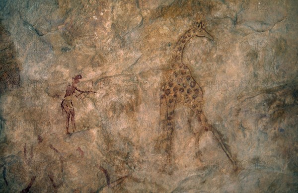 LIBYA, Wadi Auis, Detail of prehistoric rock art depicting giraffe and hunter.