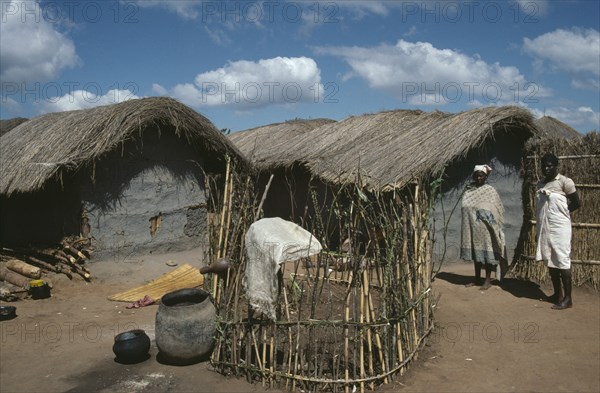 MALAWI, Dedza District, Refugees, "Small, enclosed vegetable plots outside tents in Mozambican refugee camp."