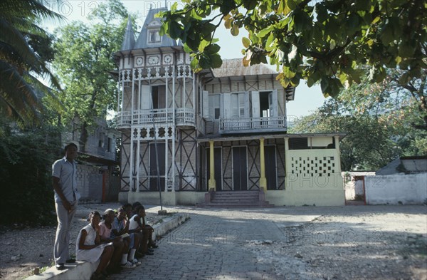 HAITI, Achitecture, Typical domestic architecture.  Colonial style home with children sitting outside.