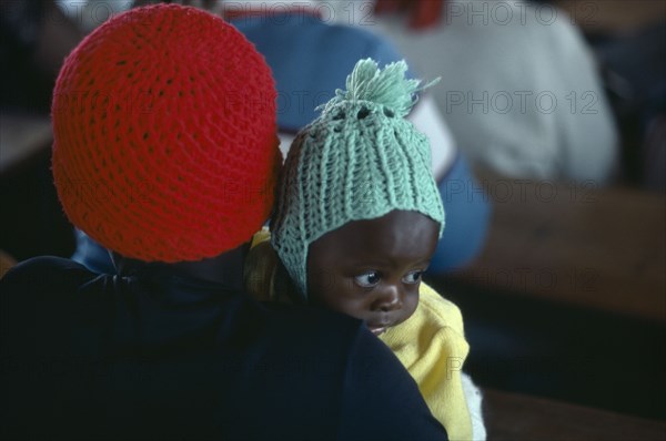 SOUTH AFRICA, Kwazulu Natal, Mother and baby attending Sunday church service.