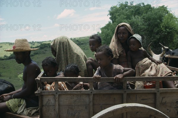 MADAGASCAR, Central, People, Family travelling in wooden ox cart.