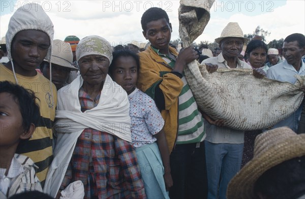 MADAGASCAR, Central, People, "Merina bone turning ceremony or famadihana in which the remains of a relative are exhumed,celebrated and danced with before being wrapped in clean shroud and reburied."