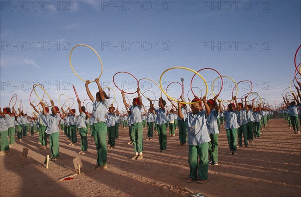 WESTERN SAHARA, SADR, "Parade of children with coloured hoops celebrating anniversary of the Polisario Front, the Sahrawi movement working towards independence."