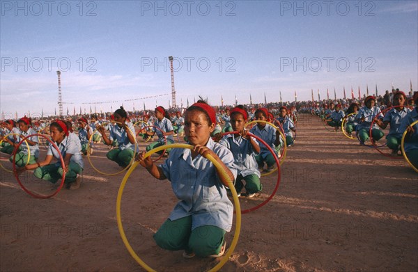 WESTERN SAHARA, SADR, "Parade of children with coloured hoops celebrating anniversary of the Polisario Front, the Sahrawi movement working towards independence."