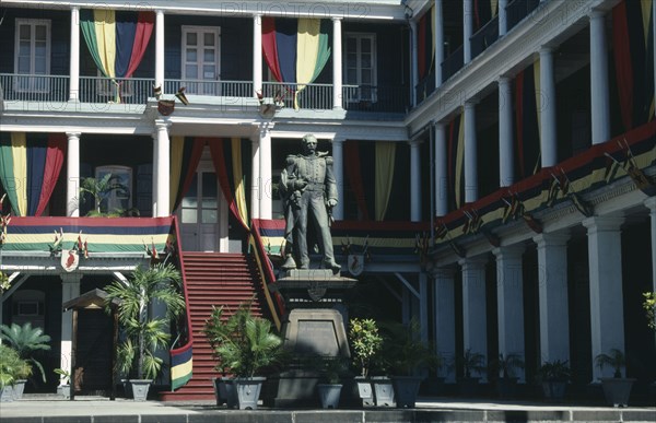 MAURITIUS, Port Louis, Exterior of Government House hung with flags and banners in celebration of Republic Day with statue of William Stevenson governor 1857-1863 in foreground.