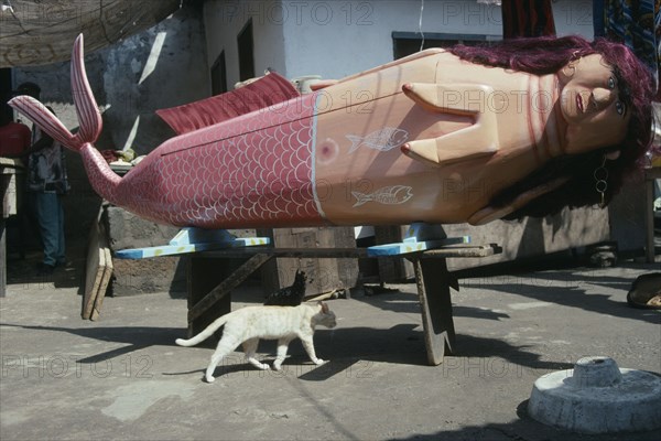 GHANA, South, Teshie, Coffin made and painted to represent a mermaid for Ga tribal priestess of the sea god Kanjar following tradition of decorating a coffin to reflect the life of the deceased.