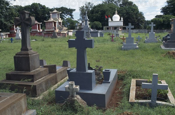 MAURITIUS, General, Crosses alongside Chinese and Islamic tombs in graveyard near Port Louis.