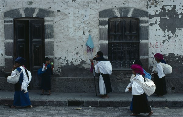 ECUADOR, Imbabura, Cotocachi, Women returning from cemetery after praying for the dead on Easter Sunday.