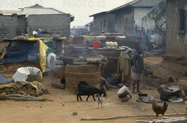 GHANA, Village Scene, "Outside ovens in village near Accra with children, goats and chickens around."