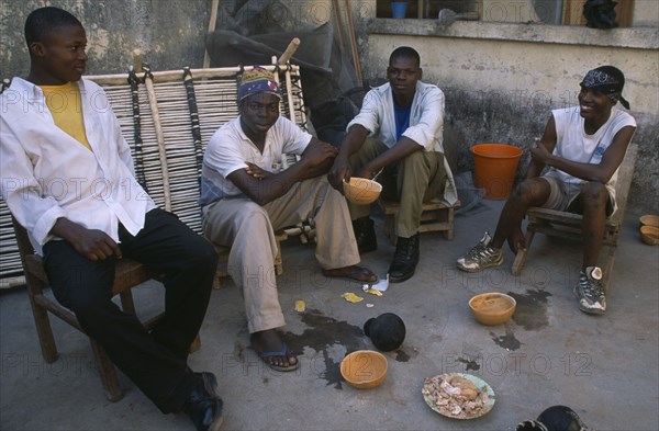 GHANA, North, Drinks, "Boys drinking pito, an alcoholic beverage made from millet or sorghum malt and commonly drunk from shared bowls. "