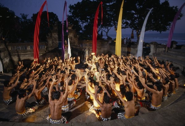 INDONESIA, Bali, Kechak dancers forming human mandala. The Kechak dance tells the story of Prince Rama and his quest to rescue his wife Sita from the demon king Ravana