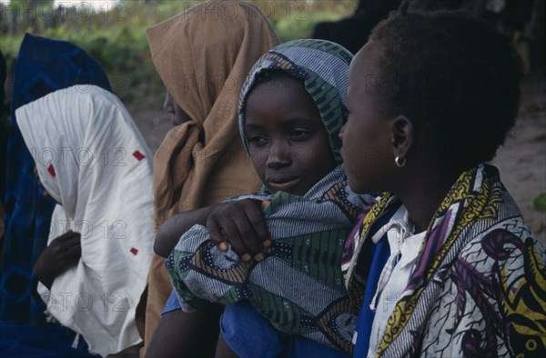 GAMBIA, People, Girls, Group of Muslim girls sat together wearing headscarfes