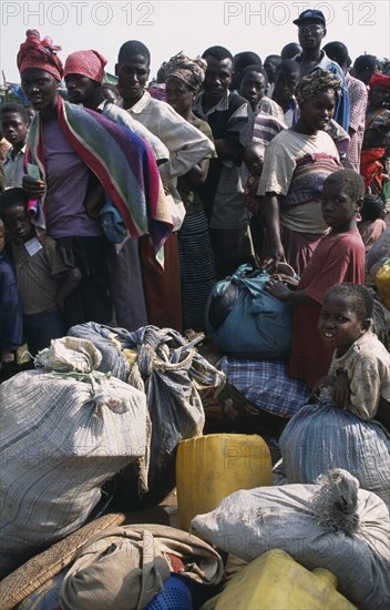 GUINEA, Kissidougou, Camp for Sierra Leonean Refugees. People with sacks moving camp