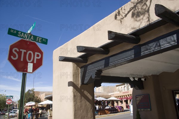 USA, New Mexico, Santa Fe, Stop sign on the Old Santa Fe Trail beside and adobe Pueblo Revival style building