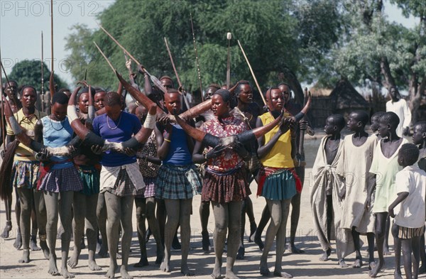 SUDAN, Tribal People, Dinka cattle festival celebrating the return of the herds to the Toich or pastureland.  Painted dancers holding decorated cattle horns.