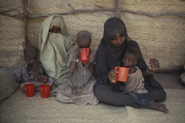 SUDAN, Red Sea Hills Province, Sinkat, Women and malnourished children at Red Cross feeding centre.