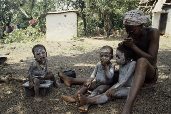 SIERRA LEONE, Mende, Children are smeared with clay to protect them from both seen and unseen dangers.