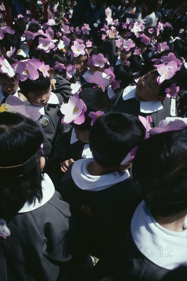 JAPAN, Honshu, Tokyo, Asakusa. Nursery school children in uniforms and flower head bands celebrating the Flower Festival at Asakusa Kannon Temple for Buddhas birthday.