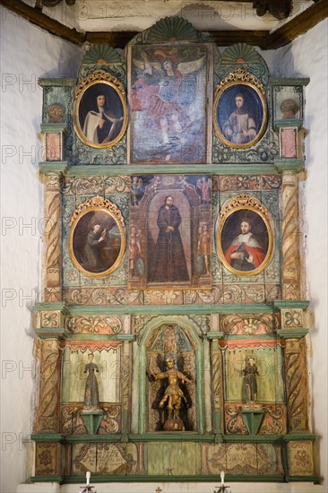 USA, New Mexico, Santa Fe, The altar panel of the San Miguel Mission church with Spanish an Native American inspired artwork