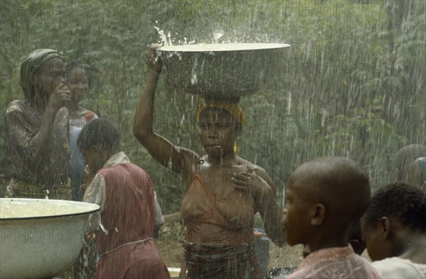 NIGERIA, Imo State, Women during wet season harvesting rainwater as part of UNICEF project