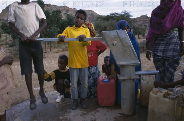 ERITREA, Asmara, Ouna Watot camp for people displaced by war with Ethiopia.  Women and children at water pump.