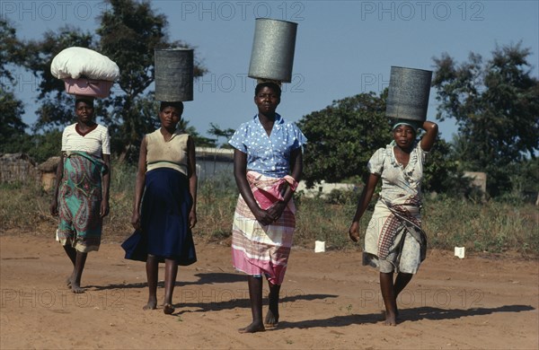 MOZAMBIQUE, Water, Group of women carrying water vessels on their heads.