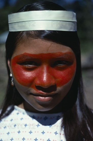 ECUADOR, People, Girls, Portrait of Auca Indian girl from Christian group with her face decorated with red Achote paint.