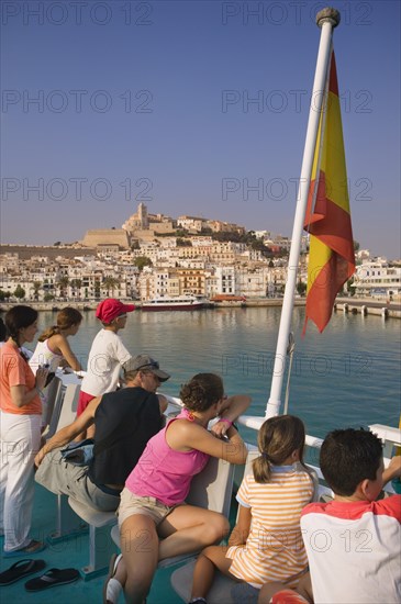 SPAIN, Balearic Islands, Ibiza, "Passengers on board a ferry leaving Eivissa for Formentera, Spanish flag."