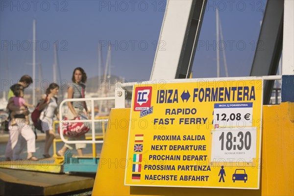 SPAIN, Balearic Islands, Ibiza, "Boarding a passenger ferry bound for Formentera, Eivissa, with next departure sign."
