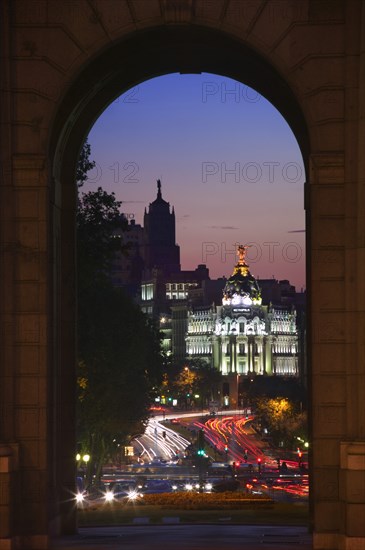 SPAIN, Madrid, "Night time view along Calle de Alcala towards the Gran Via from the Puerta de Alcala, seen through an arch."
