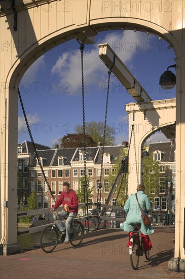 HOLLAND, North , Amsterdam, "Cyclists crossing Magere Brug, Skinny Bridge."