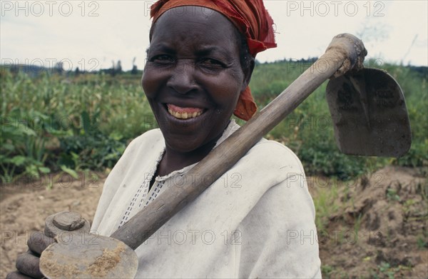 RWANDA, Giterama, "Portrait of woman with hoe, a member of the Women’s Agricultural Association reformed after the genocide."