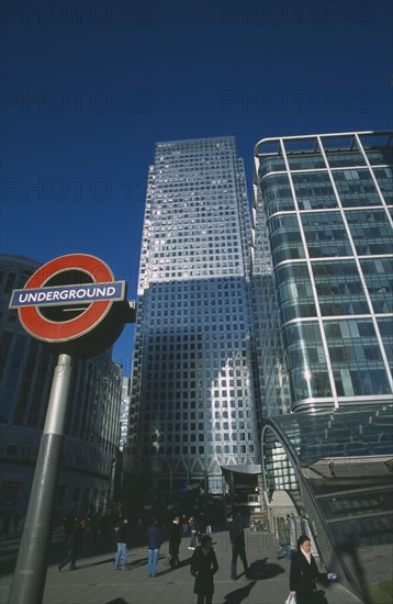 ENGLAND, London, Canary Wharf. The tower at 1 Canada Square with Underground station sign in the foreground.