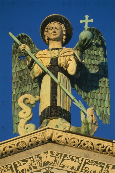 ITALY, Tuscany, Lucca, San Michele in Foro.  Detail of carved archangel figure.