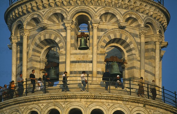 ITALY, Tuscany, Pisa, Campanile or Leaning Tower of Pisa.  Detail of top level and bells with visitors circling gallery.