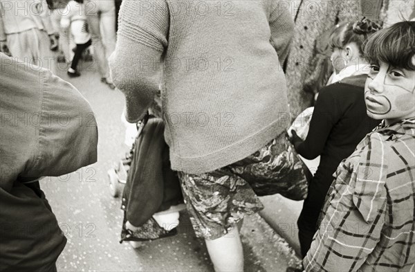 FRANCE, Bouches du Rhone, Arles, A girl dressed as a clown follows her mother during a festival.