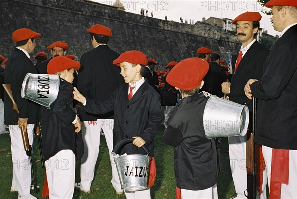 SPAIN, Hondarabia, The Basque Country, Basque marchers and fire boys relax before the festival of El Alarde on 8 September.