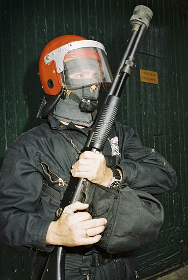 SPAIN, Hondarabia, The Basque Country, Basque riot policeman holding gun during the festival of El Alarde on 8 September