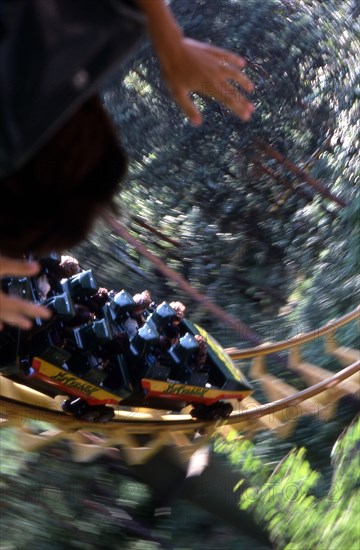 USA, New Hampshire, Salem, "Canobie Lake Park, Roller coaster ride whilst going round track."