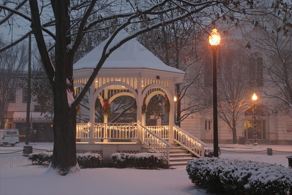 USA, New Hampshire,  Keene Common, "Gazebo or band stand in early morning snowstorm, Christmas Decorations, lampposts."