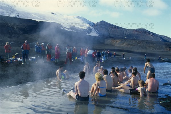 ANTARCTICA, Antarctic Peninsula, Deception Island, Tourists bathing in hot springs at Pendulum Cove.