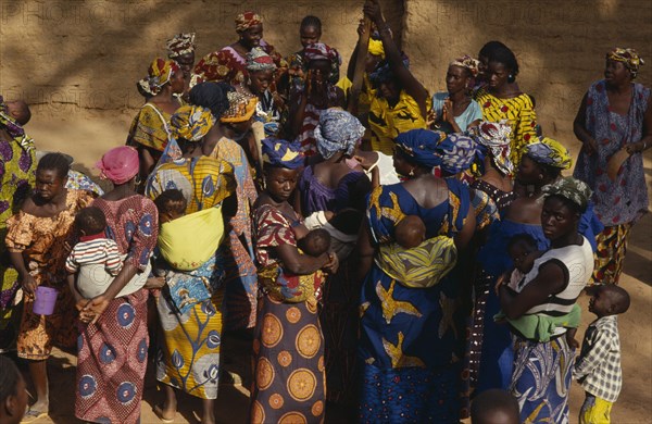 MALI, Kolokani Village, Women pound millet and sing and dance in celebration during traditional funeral ceremony.